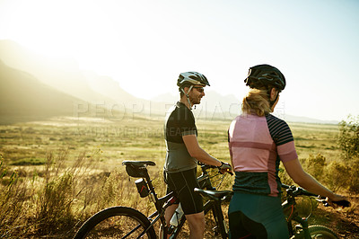 Buy stock photo Cycling, talking and fitness with couple in nature for workout break, relax and bonding together. Wellness, triathlon training and resting stop with man and woman with bicycle outdoor for space