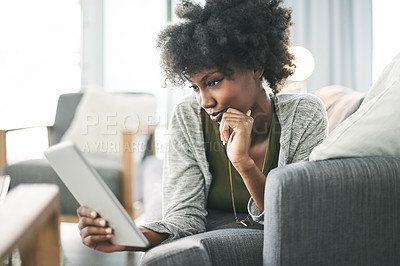 Buy stock photo Black woman, happy and relax on sofa with tablet, streaming or laying with film subscription in home. African person, smile and tech on couch for application, social media or movies at apartment