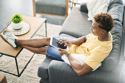 Buy stock photo Break, scroll and tablet screen with man on sofa in home living room to search for social media review. App, relax and weekend with person reading information online for me time planning from above