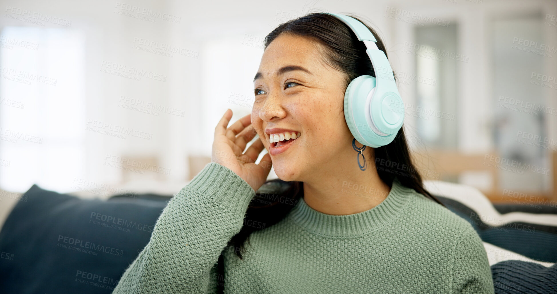 Buy stock photo Headphones, music or asian woman on sofa in home for audio streaming or entertainment app. Happy, female person or smile with sound or network connection for subscription, weekend or holiday in house
