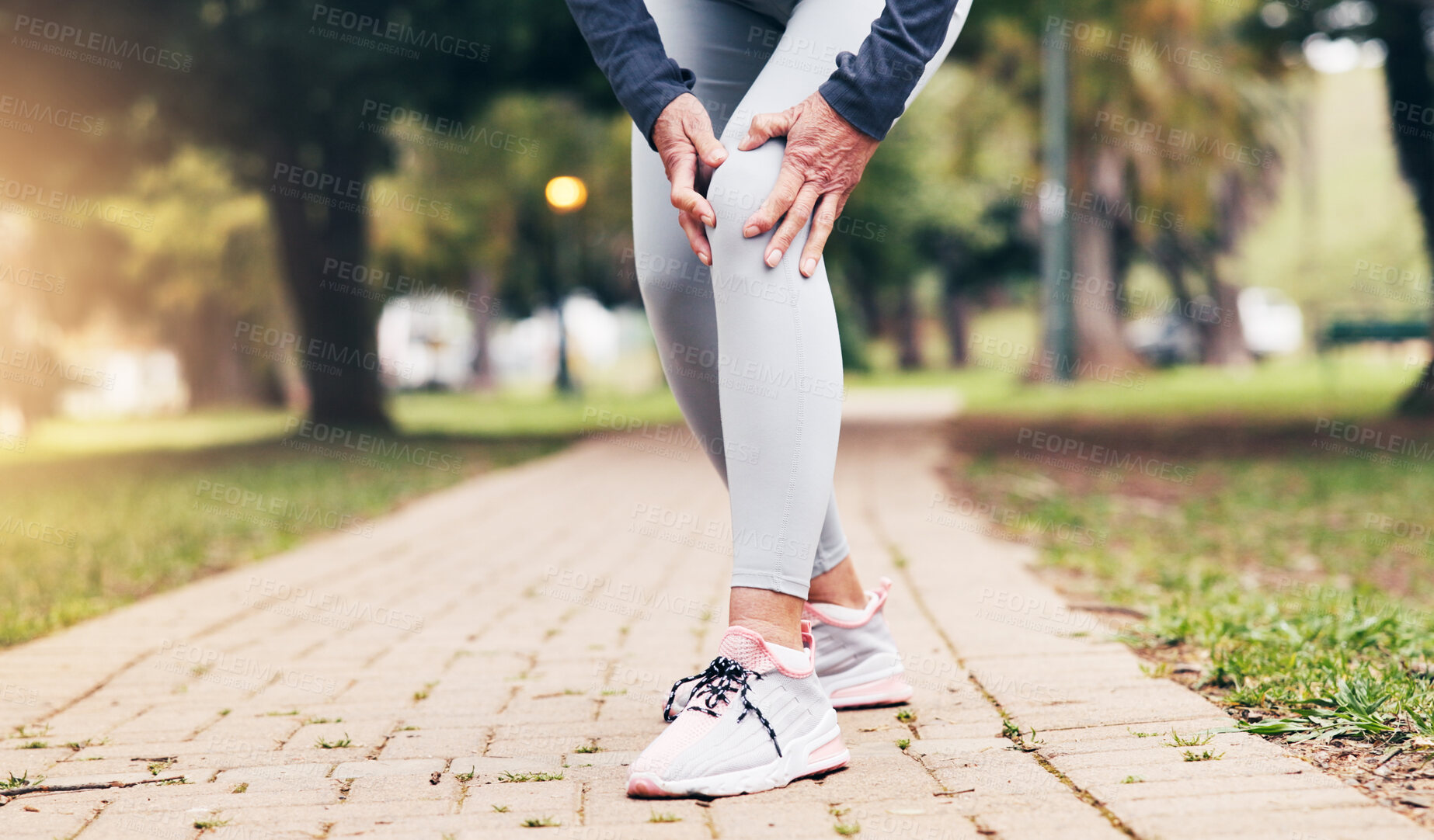Buy stock photo Senior, person and hands with knee pain in park for outdoor injury, accident or overworked strain. Active, elderly or sore leg with joint inflammation for muscle tension, mistake or fall in nature