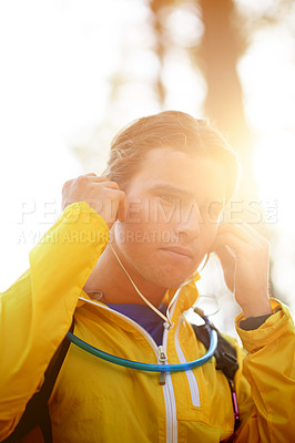 Buy stock photo Fitness, man and hiking in forest with earphones for music playlist, exercise podcast and travel adventure. Sunlight, athlete and trekking in nature with audio album, radio sound and wellness journey