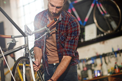Buy stock photo Man, bike and repair wheels at garage with services, equipment and problem solving at small business. Person, technician and bicycle mechanic with tyres, safety check and inspection at workshop