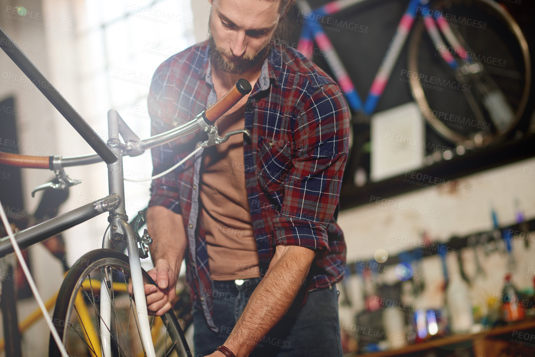 Buy stock photo Man, bike and repair wheels at garage with services, equipment and problem solving at small business. Person, technician and bicycle mechanic with tyres, safety check and inspection at workshop