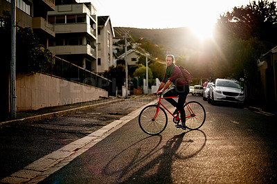 Buy stock photo Morning, man or bicycle in city for eco friendly transport, commute or entrepreneur. Outdoor travel, bike or designer on road in urban town with sunrise, fashion or confidence for creative career