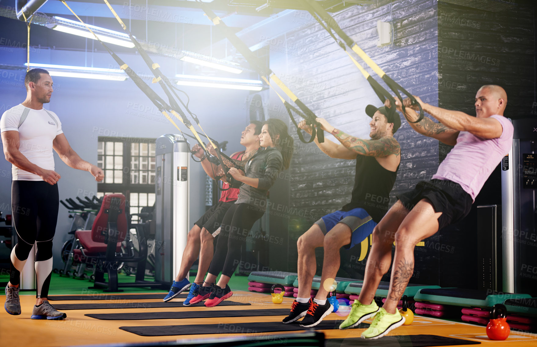 Buy stock photo Coach, people and suspension trainer in class for body, wellness and bodybuilding exercise. Instructor, active and athletes in training group with cable equipment for muscle power, workout or fitness