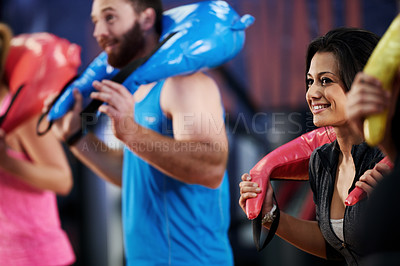 Buy stock photo Fitness, carry or happy woman with sand bag for training class, workout or core strength in club. Athletes, lifting and people in gym with weight equipment for cardio wellness, body health or support