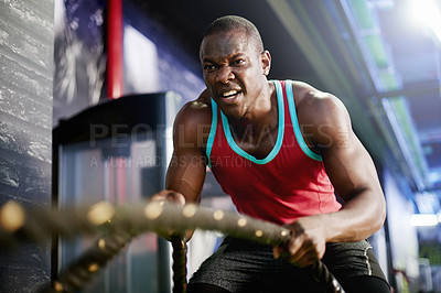 Buy stock photo Battle rope, workout and fitness with black man in gym for bodybuilder, training and muscle challenge. Exercise equipment, resilience and athlete strength with person in sports club for wellness
