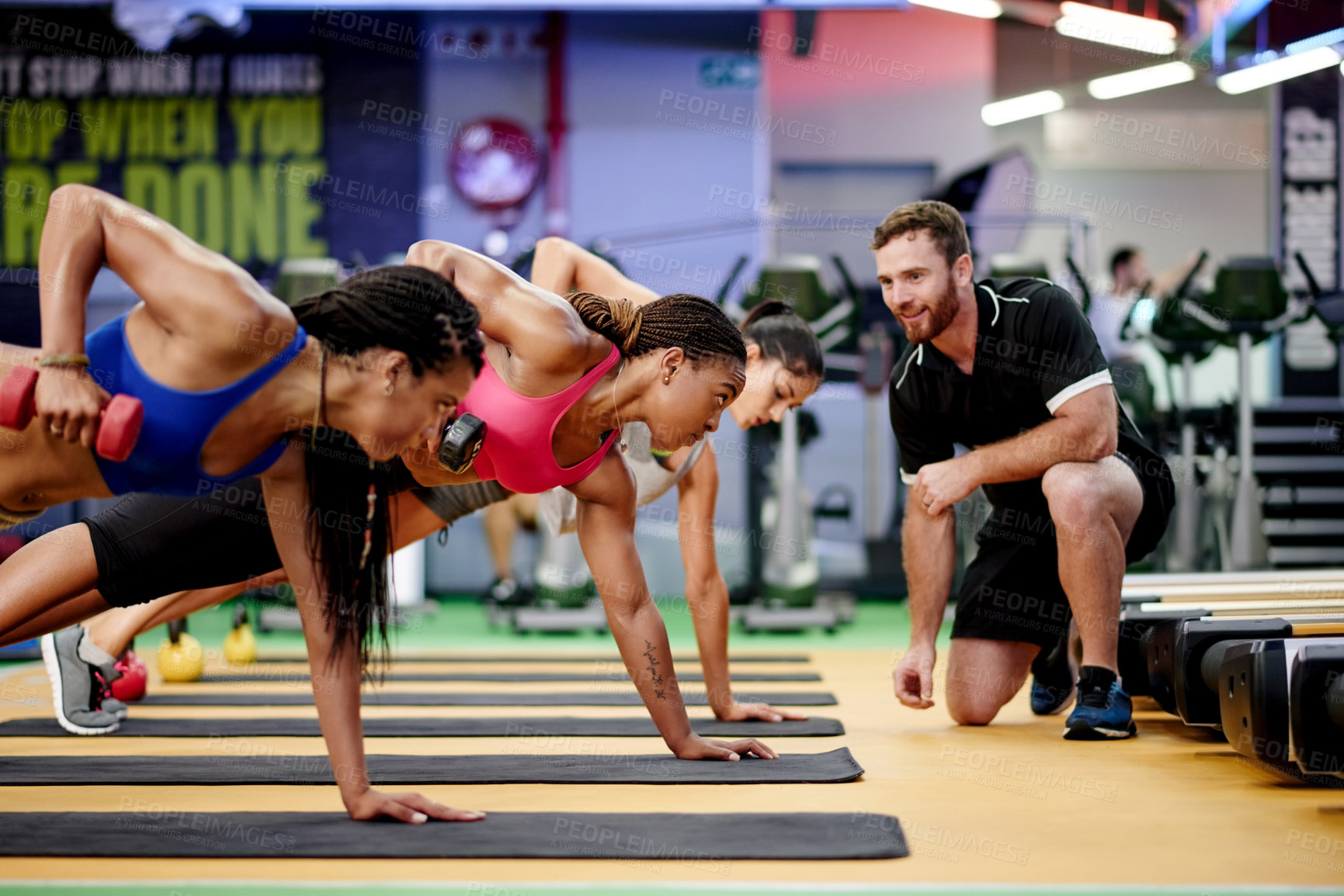 Buy stock photo Fitness, dumbbell and women with personal trainer in gym for training, muscle strength and health. Sports center, coach and people with weights for wellness, workout and challenge in exercise class
