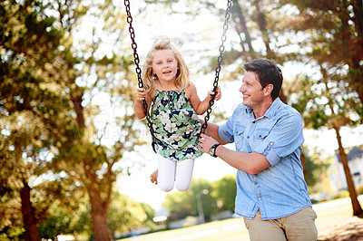 Buy stock photo Happy man, playground and child at park with swing in air, bonding and sunlight for fun childhood memories. Smile, father and daughter outdoor with nature, laugh together and playing in portrait
