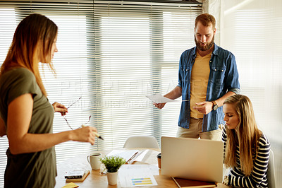 Buy stock photo Documents, laptop and meeting with designer people in office together for brainstorming. Collaboration, computer and creative planning with employee team in design workplace for business discussion