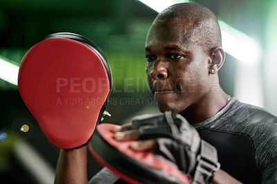 Buy stock photo Black man, boxer or trainer with gloves for block, self defense or martial arts training in gym. Male person, African coach or boxing mentor with pads for fitness, fighting or exercise in health club