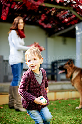 Buy stock photo Happy boy, child and playing with ball for childhood, weekend or break with dog in backyard. Kid, son and mother with playful pet for game of fetch, catch or outdoor bonding together on grass or lawn