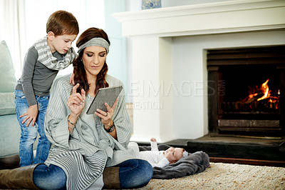 Buy stock photo Tablet, mother and children in home for learning, storytelling or bonding with app on internet. Technology, kids and parent with online education, reading ebook or relax at fireplace with family