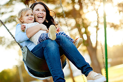 Buy stock photo Mom, laugh and swing with child, playground or affection for toddler in nature or playing with girl. Outdoor, woman and fun with daughter on weekend, happy or childcare on holiday, family and park