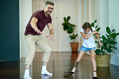 Buy stock photo Father, child and slide on clean floor, funny and bonding together with hygiene in family home. Dad, girl and play game with energy, excited parent and laughing for shine with socks for housekeeping