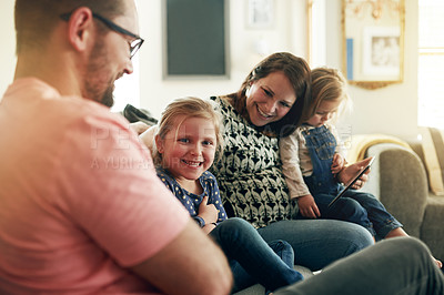 Buy stock photo Love, portrait and smile of girl with family on sofa in living room of home for child development. Cute, happy or security with pregnant mom, dad and daughter kids in apartment together for bonding