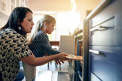 Buy stock photo Oven, baking and teaching with mother and daughter in kitchen for cupcake, cooking and learning. Support, food and help with woman and child in family home for dessert, bonding and love together