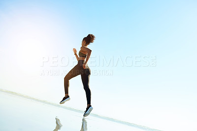 Buy stock photo Fitness, woman and running at beach for exercise, body wellness or health with mockup space. Ocean, runner and cardio training outdoor for endurance challenge, workout or sports with energy in nature