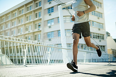 Buy stock photo Running, fitness and legs of man in city for cardio challenge, marathon practice and sports athlete. Workout, training and wellness with low angle of person on bridge for race, health and endurance