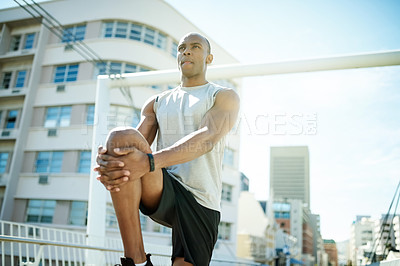 Buy stock photo Man, low angle and stretching legs for fitness, warm up and city for cardio preparation. Male person, urban street and athlete for workout, getting ready and exercise for marathon training for sport