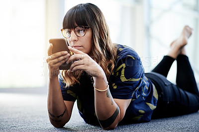 Buy stock photo Woman, phone and reading on office floor with relax, social media and message in text. Female person, smartphone and communication for website, update and workplace conversation on contact app
