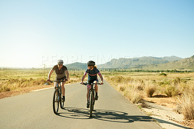 Buy stock photo Couple, cycling or road with bicycle in nature for fitness, exercise or outdoor workout together. Active man, woman or cyclist with bike on street for race or marathon in countryside on mockup space