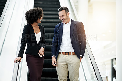 Buy stock photo Business, people or talking on escalator in building for corporate growth, meeting briefing or chat. Learning, mentor or intern with discussion on moving stairs for career planning or company insight