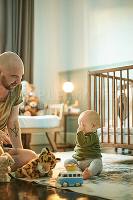 Buy stock photo Man playing with tired baby on nursery floor, new dad and infant bonding with toys in bedroom at home. Family, love and development, father and child in playroom, teaching and learning with fun toy.