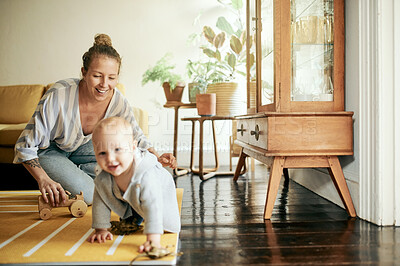 Buy stock photo Baby, child development and funny mom playing with infant on the floor of a house or home and bonding together. Care, laughing and single parent or woman having fun with newborn kid with happiness