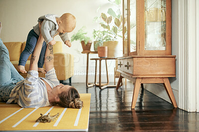 Buy stock photo Family, play and mother lift baby in home for bonding, quality time and relax together on floor. Living room, love and happy mom with kid playing for child development, care and loving on weekend