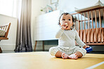 Child development, toys and a baby sitting on the floor in it's bedroom at home while playing or looking curious. Children, learning and growth with an adorable little girl kid in a house to play