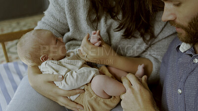 Buy stock photo Hands, mother or father with baby in a family to relax or bond together for care or child development. Hug, parents closeup or proud dad with mom or newborn infant for support, trust or love at home