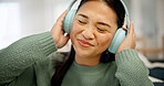 Headphones, music or asian woman with audio streaming for podcast or entertainment in home. Happy, female person or subscription with smile, sound or network connection for weekend or app in house
