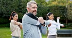 Man, stretching and personal trainer outdoor with fitness class, smile and preparation for workout. Mature person, exercise coach and happy with warm up for training, vitality and wellness in garden.