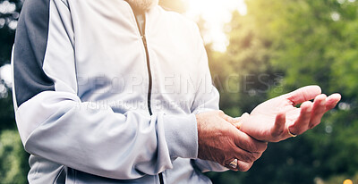 Buy stock photo Senior, person and hands with wrist pain in park for outdoor accident, workout strain or pressure. Elderly, fitness and sore arm with lens flare for carpal tunnel syndrome or discomfort in nature