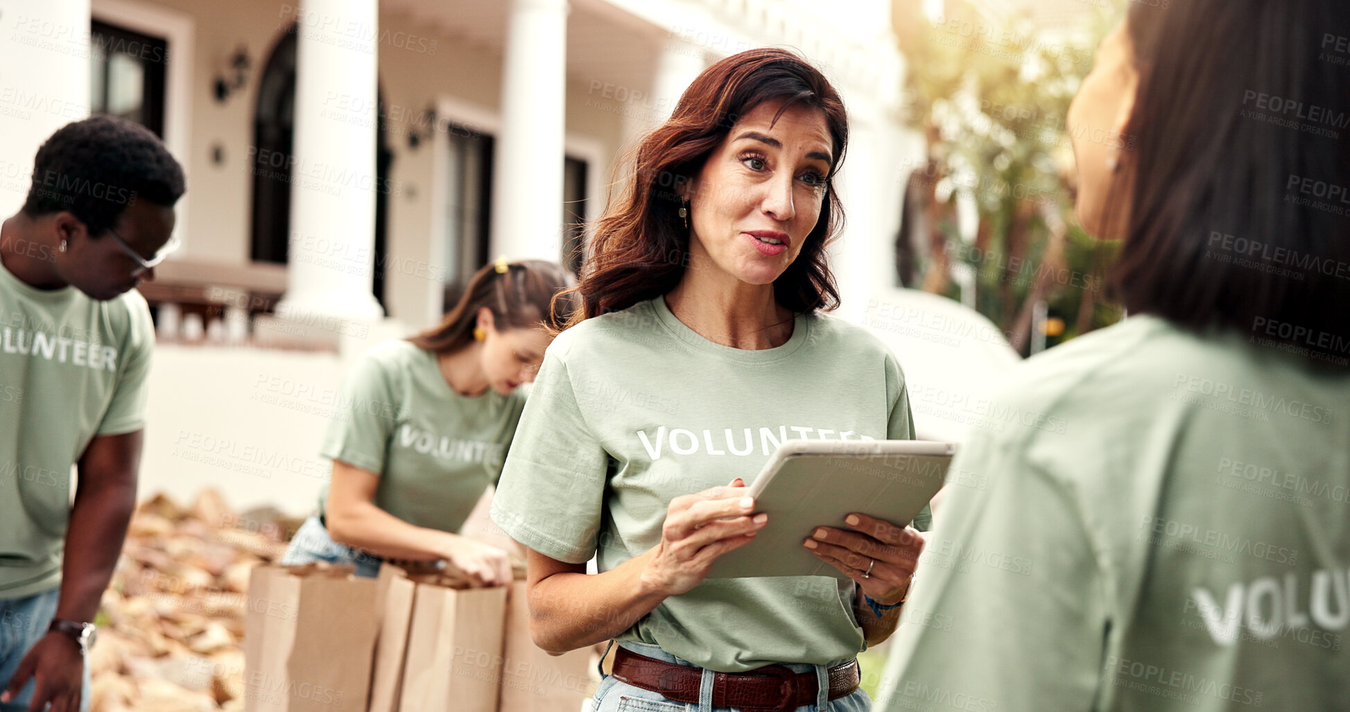 Buy stock photo Smile, woman and tablet outdoor for volunteering, sign up and appoint task for community outreach. Happy, coordinator and people with digital for charity, participation and job allocation for welfare