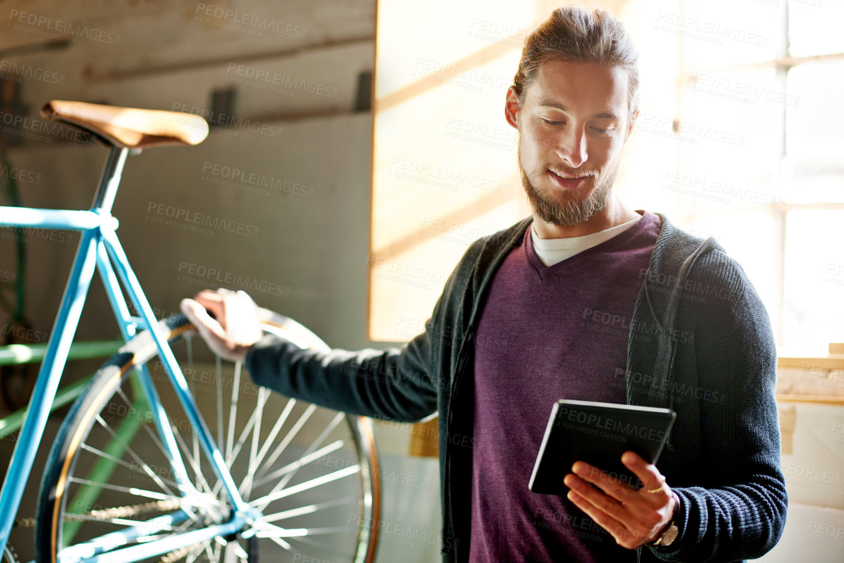 Buy stock photo Man, tablet and bike repair at workshop with smile for schedule, invoice and research for maintenance. Person, bicycle and tech with application, inspection and restoration services at small business
