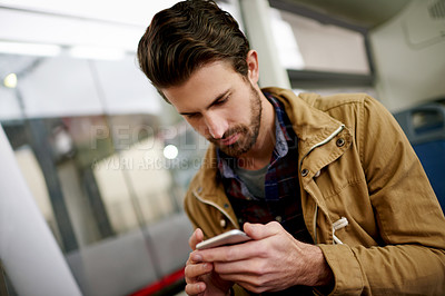 Buy stock photo Phone, travel and man on bus with reading online news, blog or update on mobile app with commute. Cellphone, communication and male person checking email, contact or notification on public transport.