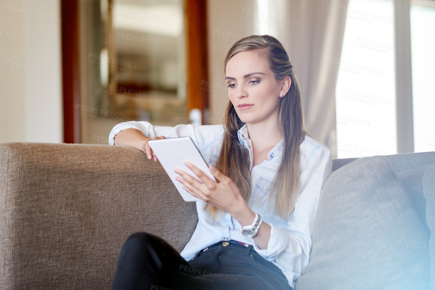 Buy stock photo Woman, tablet and relax on sofa, scroll or search for ebook, choice or film streaming at home. Person, click and tech in lounge with application, subscription and social network on couch at house
