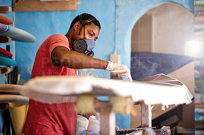 Buy stock photo Workshop, PPE and black man with surfboard, fiberglass and creative for talent and hobby skills. Craftsman, artist and repair with mask for design, manufacturing and custom work for artisan craft