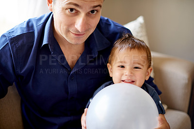 Buy stock photo Balloon, birthday and portrait of father with son on sofa in living room of home for milestone. Celebration, excited or gift with happy boy child and single parent man in apartment together for fun