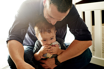 Buy stock photo Bite toy, father and toddler in home with playing, bonding and relationship growth for love. Happy, care and man with boy kid in nursery with teething plushie, development and relax in family house