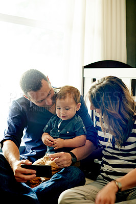 Buy stock photo Family, relax and toddler with phone for entertainment or childhood development in home. Mom, dad or people with boy child with mobile smartphone app for learning, show or bonding together in nursery