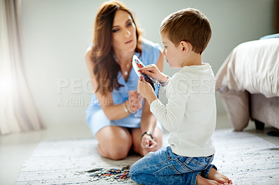 Buy stock photo Woman, child and puzzle for learning with education toys, development and bonding in home. Mother, son and help with growth, support and love or logic activity for academic games on bedroom floor
