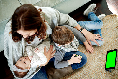 Buy stock photo Mom, baby and kid with tablet with green screen for bonding, love or child development app. Above of parent, son and mother on floor in home with mockup, comfort and relax for break and entertainment