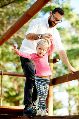 Buy stock photo Playground, happy and dad with child in park for bonding, playing games and having fun. Family, sunlight and father with girl for help, support and relax on holiday, jungle gym or activity on weekend