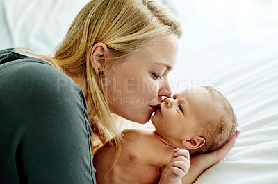 Buy stock photo Love, mother and kiss newborn on bed for connection, bonding together and protection in nursery. People, baby and new mom with affection in home for early childhood development and morning routine
