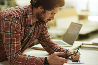Buy stock photo Man, writing and phone in carpentry workshop for trade, stock and supply chain. Craftsmanship, research or artisan planning with mobile in warehouse for notes, project checklist and small business