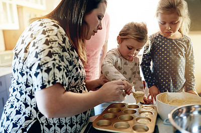 Buy stock photo Cupcake, baking and help with mother and daughter in kitchen for snack, cooking and learning. Support, food and teaching with woman and children in family home for dessert, bonding and love together